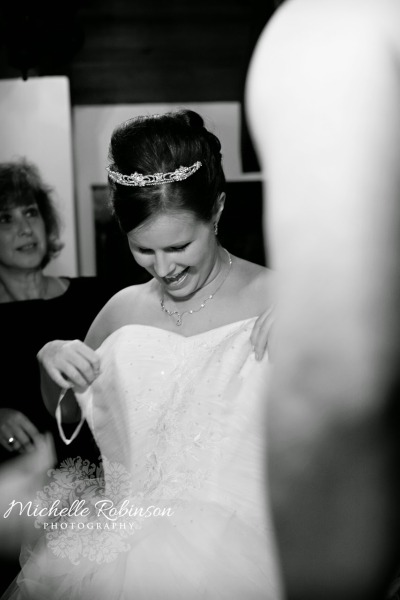 Bride putting on Cinderella Wedding Dress